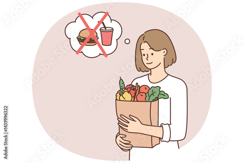 Vegetarian woman holding paper bag with fresh vegetables in hands refusing to buy fast food