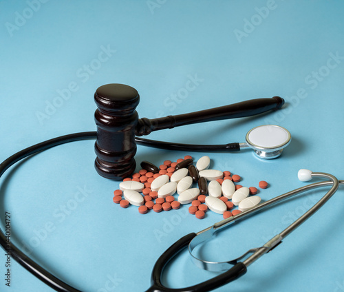 Medical negligence concept. Patient safety incidents due to medical negligence. Malpractice. Gavel, stethoscope and pills.