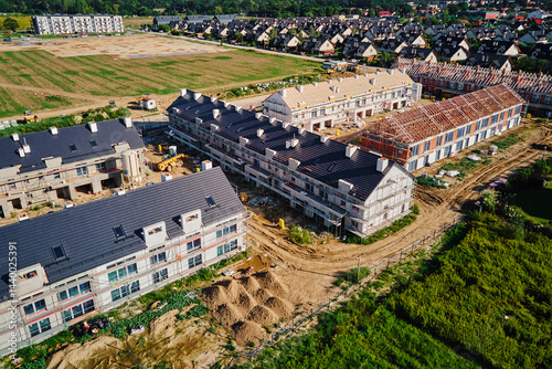 Obraz na płótnie Aerial view of large housing estate under construction with modern residential buildings in small town. Suburban neighborhood w salonie