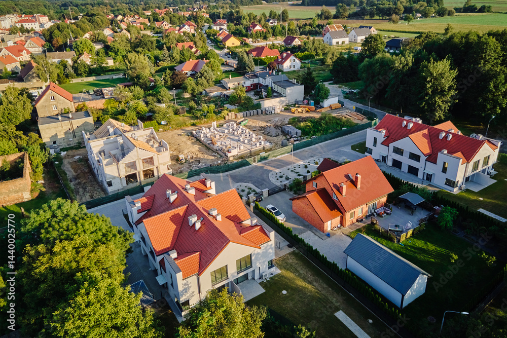 Aerial view of residential neighborhood with modern houses and construction site. Concept of real estate development and suburban living