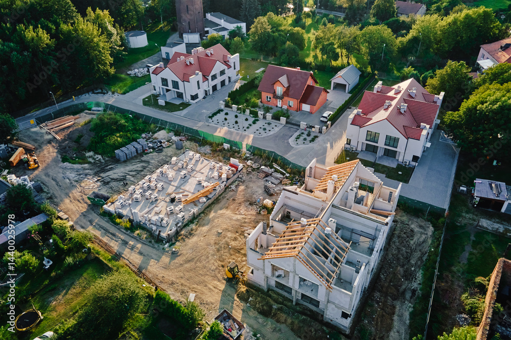 Aerial view of residential neighborhood with modern houses and construction site. Concept of real estate development and suburban living