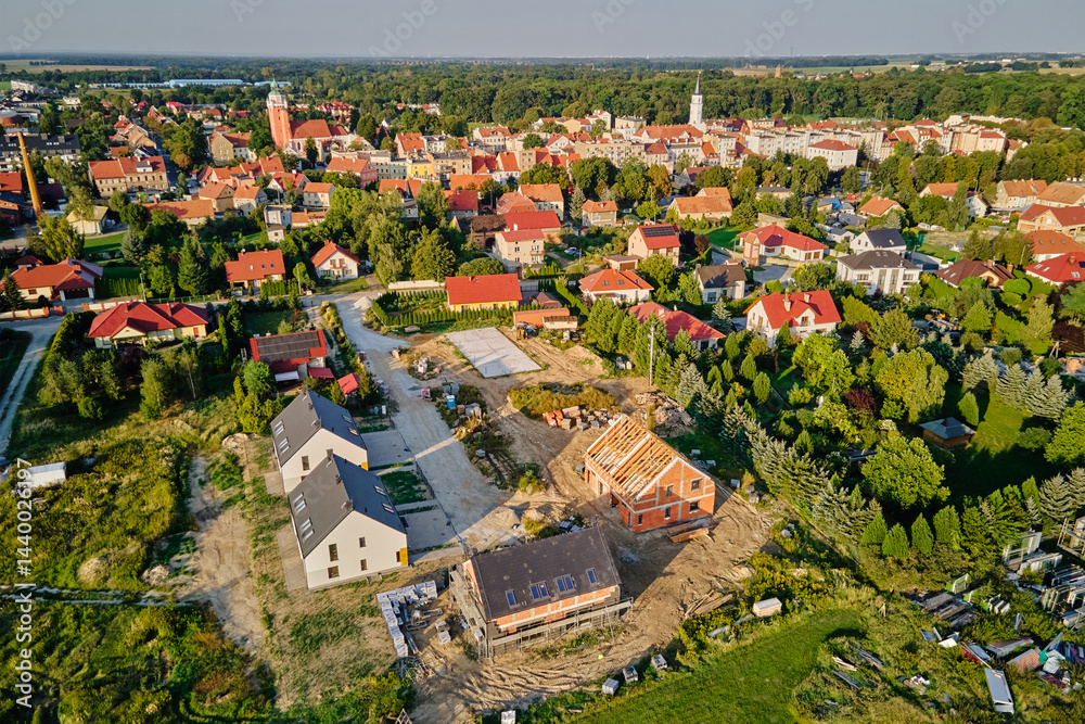 Aerial view of residential neighborhood with modern houses and construction site. Concept of real estate development and suburban living in small town