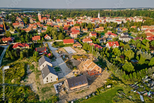 Aerial view of residential neighborhood with modern houses and construction site. Concept of real estate development and suburban living in small town