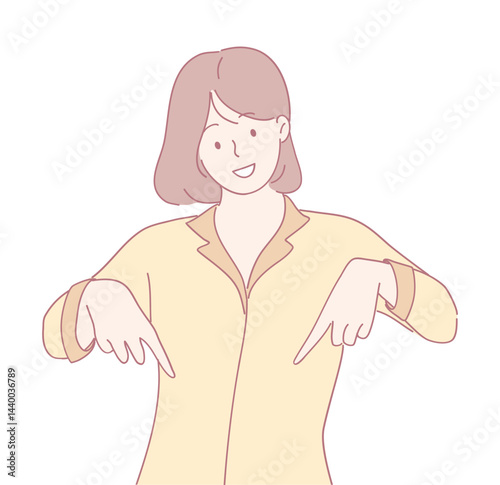 A joyful woman dressed in casual wear is playfully pointing downwards while wearing a friendly expression