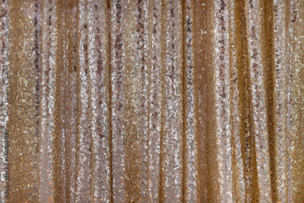 Fototapeta premium Golden sequins fabric used in fashion, interior design or event decoration with an elegant shimmering effect, glamorous textile background, inspiration for clothing or accessory creation or room decor