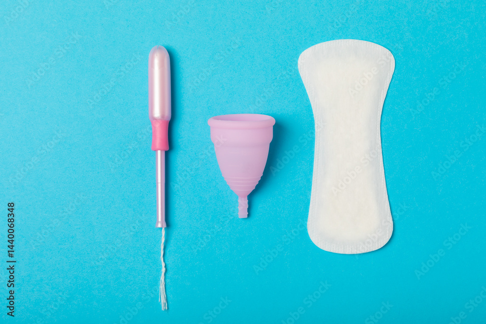 Menstrual cup on a bright background. Sanitary napkins, tampons and menstrual cup.Concept of critical days, menstruation.feminine hygiene product. Women health concept.Premenstrual syndrome.Copy space