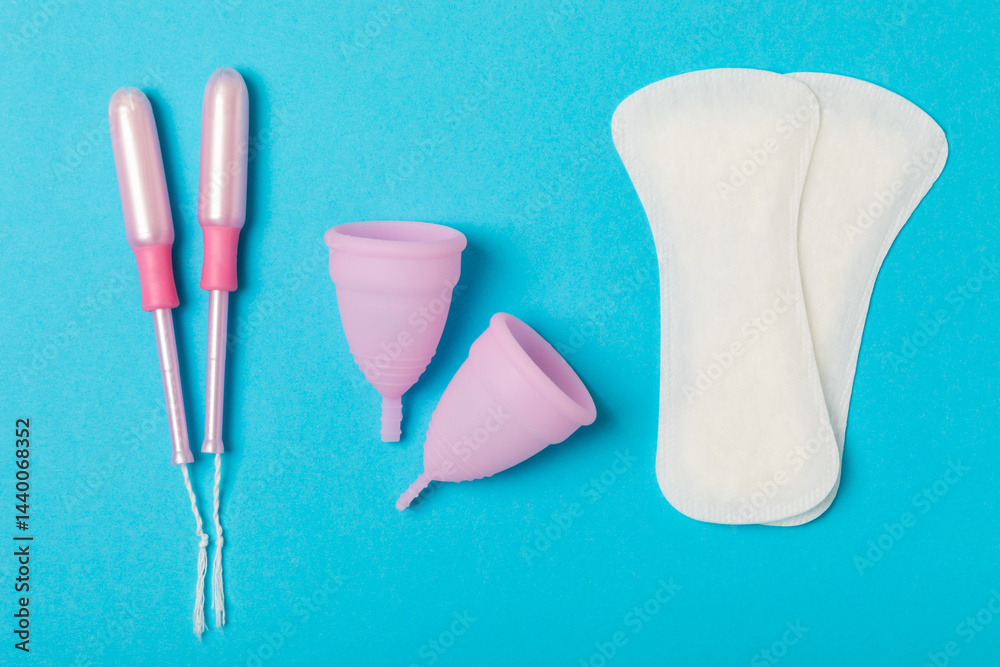 Menstrual cup on a bright background. Sanitary napkins, tampons and menstrual cup.Concept of critical days, menstruation.feminine hygiene product. Women health concept.Premenstrual syndrome.Copy space