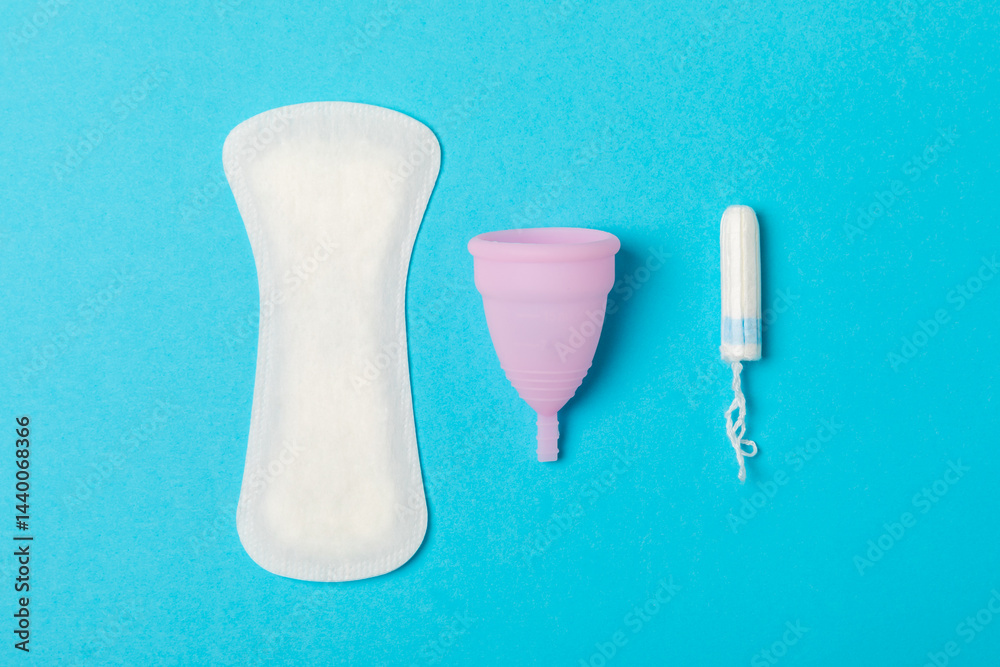 Menstrual cup on a bright background. Sanitary napkins, tampons and menstrual cup.Concept of critical days, menstruation.feminine hygiene product. Women health concept.Premenstrual syndrome.Copy space
