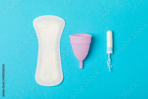 Obraz na płótnie Menstrual cup on a bright background. Sanitary napkins, tampons and menstrual cup.Concept of critical days, menstruation.feminine hygiene product. Women health concept.Premenstrual syndrome.Copy space w salonie