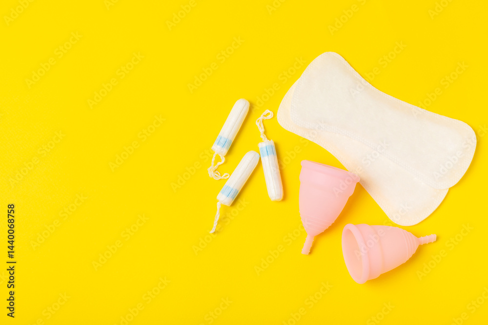 Menstrual cup on a bright background. Sanitary napkins, tampons and menstrual cup.Concept of critical days, menstruation.feminine hygiene product. Women health concept.Premenstrual syndrome.Copy space