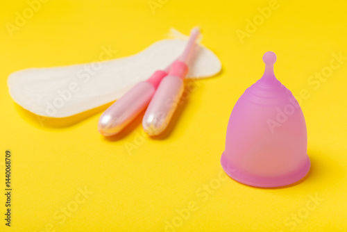 Obraz na płótnie Menstrual cup on a bright background. Sanitary napkins, tampons and menstrual cup.Concept of critical days, menstruation.feminine hygiene product. Women health concept.Premenstrual syndrome.Copy space w salonie