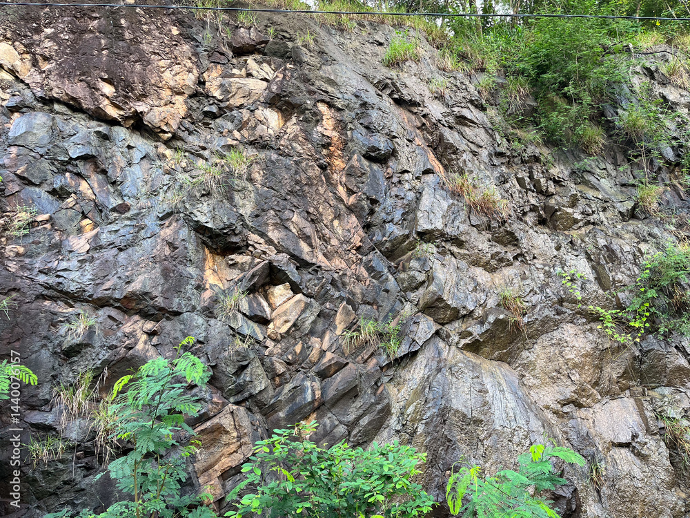Fototapeta premium Wet rock wall after rain
