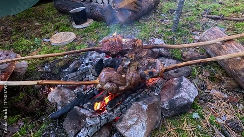 cooking meat on a fire in the forest