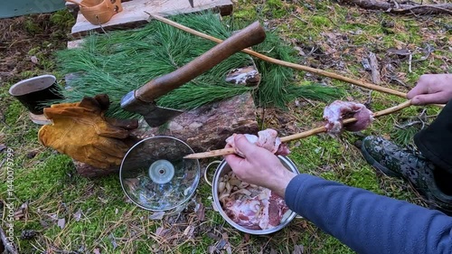 cooking meat on a fire in the forest