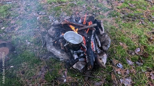 Making a drink on a fire in the forest. Tea. Coffee on the fire.