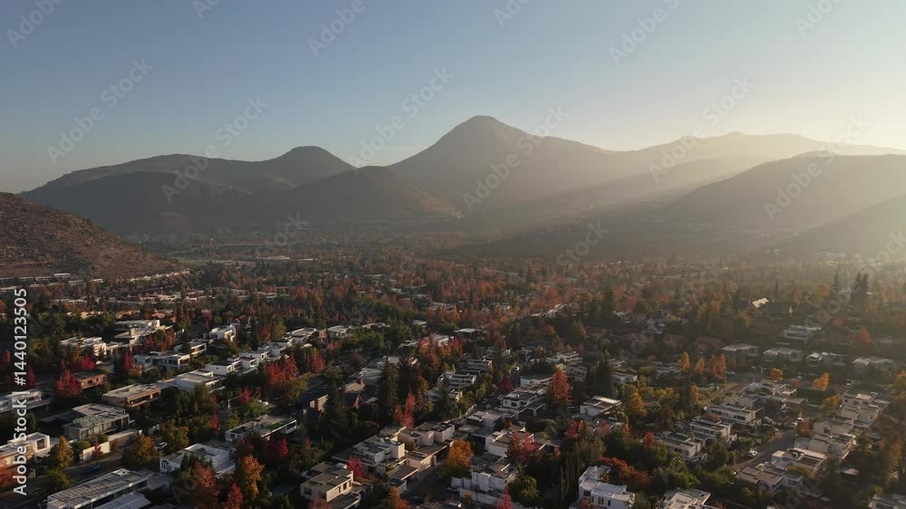 aerial drone footage of the capital of Chile Santiago city at sunset time with mountains on the background