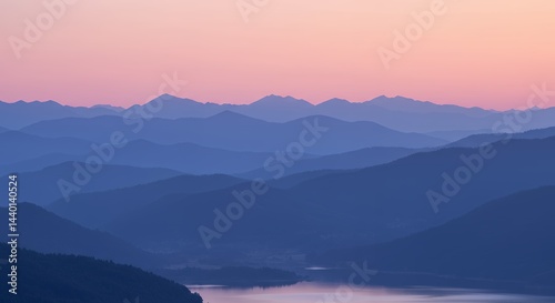 Mountains Layers at Sunset over Lake with Sky Reflection