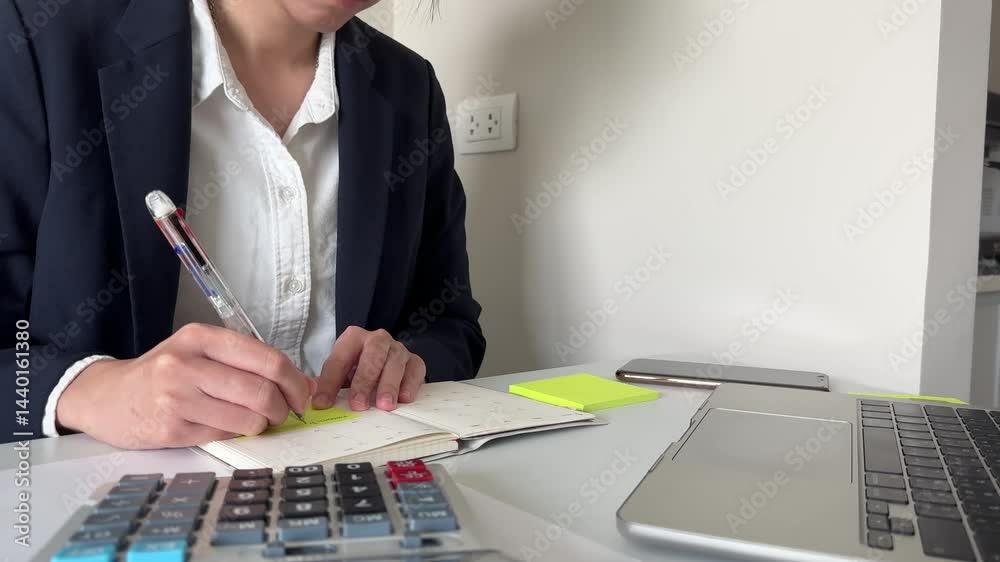 Close-up businessman writing on note pad book pen finance calculation planning analysis document office accounting investment concept