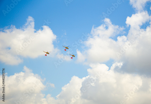 Photography Helicopters carrying Vietnam flags in background of blue sky with cotton floatin