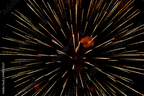 Spectacular golden fireworks show in night sky, shining sparks and trails perfect for celebration and backgrounds