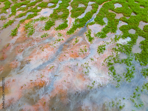 фотографія Emission of pollution by sewage from the city fall into the pond with green grass,Water pollution, environmental problems