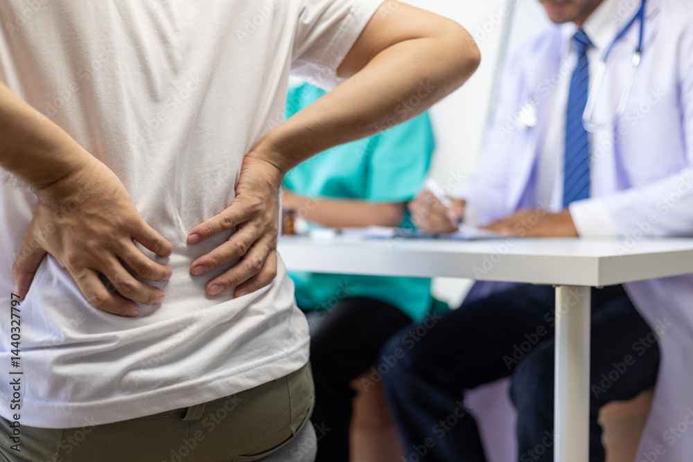Fototapeta premium A man has back pain and waist pain, He is consulting a specialist in an examination room at a hospital.