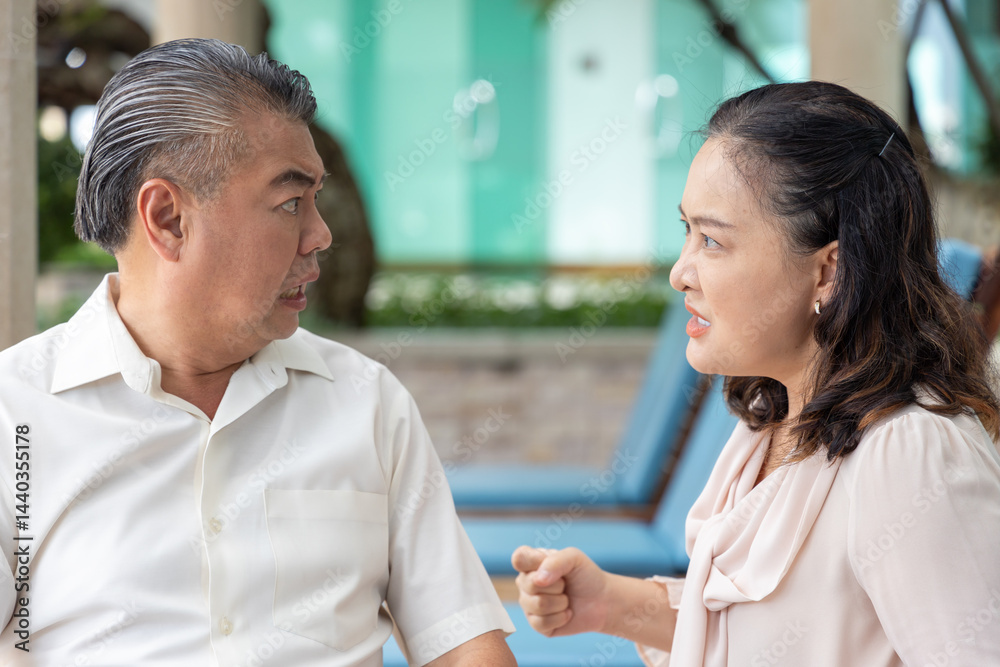 Naklejka premium Angry Asian Senior couple having argument with bad mood, staring at each other