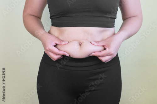 Obraz na płótnie Women body fat belly. Obese woman hand holding excessive belly fat. w salonie