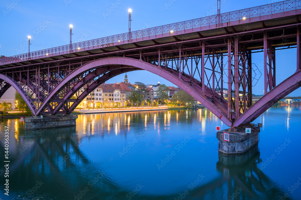 Stunning evening view of Drava River and iconic bridge in Maribor Slovenia