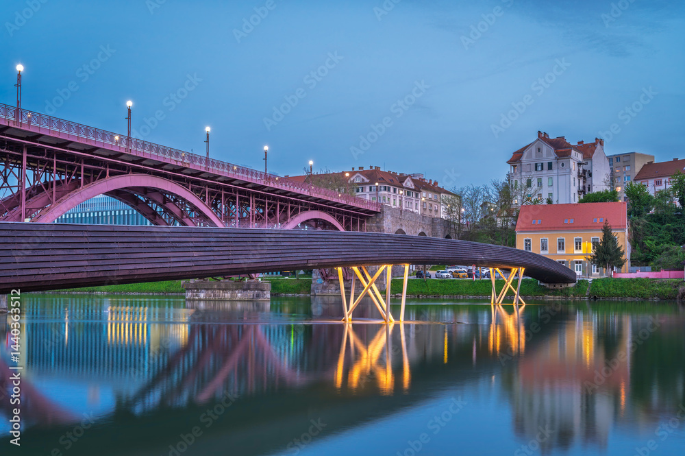 Spring evening by the Drava River with illuminated bridge in Maribor - Slovenia