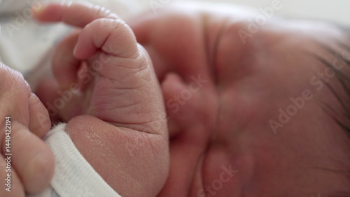 Close-up of a newborn baby gesticulating in sleep, with tiny hand movements and a slight grimace on the baby's face-SD 480p