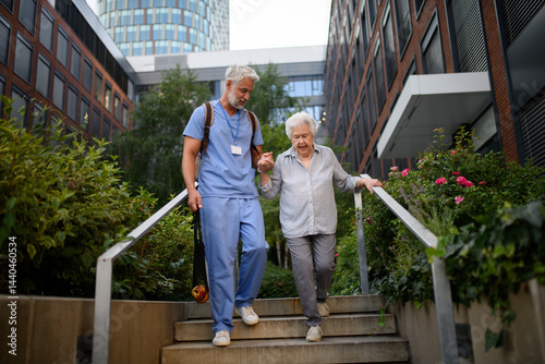 Photography Caring healthcare worker helping elderly woman walk the stairs.