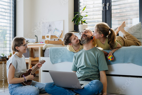 Father with three daughters trying to work from homeoffice.