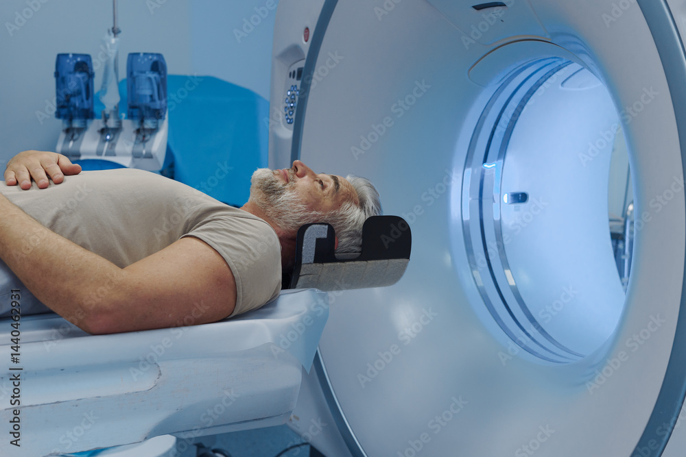 © Halfpoint - Male patient undergoing CT scan examination in hospital. © Halfpoint - Male patient undergoing CT scan examination in hospital.