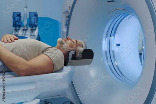 Quadro su tela Male patient undergoing CT scan examination in hospital.