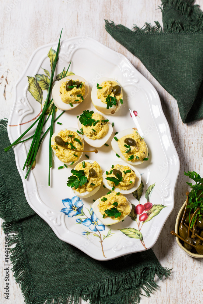 Eggs stuffed with mousse of egg yolk, mayonnaise, mustard and capers.