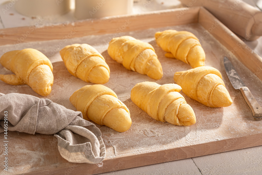 Sweet french croissants preparing from raw dough.