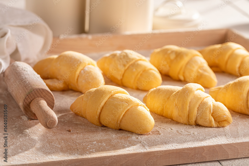 Traditionally french croissants preparing from raw dough.