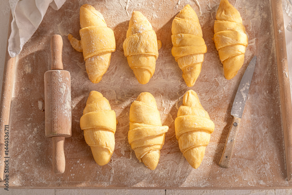Traditionally french croissants preparation for baking in home.
