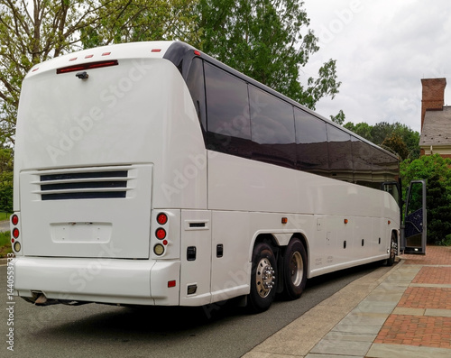 rear and side view of  white tour bus