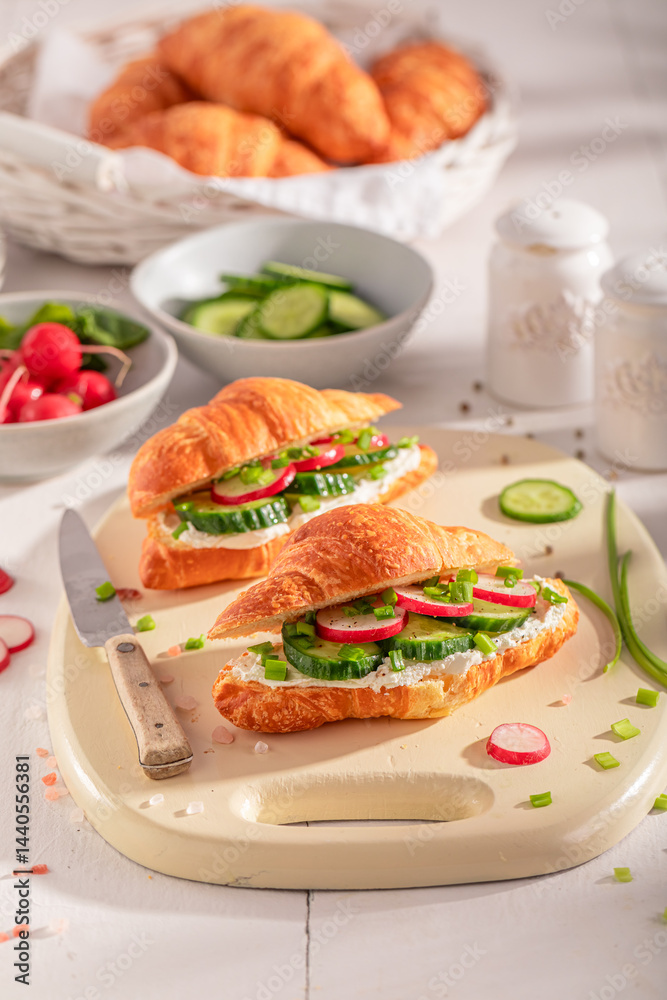 Golden and healthy french croissant with cottage cheese and cucumber.