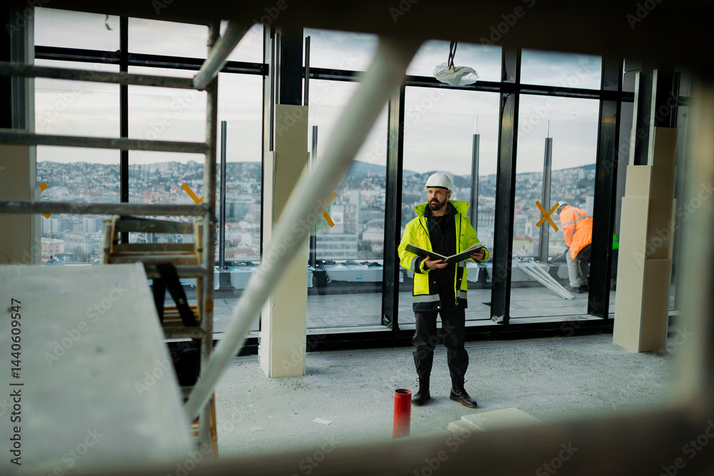Fototapeta premium Engineer overseeing city construction project with blueprints in hand.