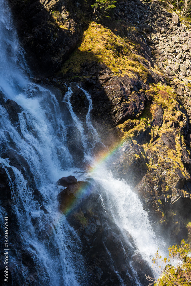 Rainbow formed in the mist of the Ars Waterfall, in the Pyrenees region of Haut-Couserans, Ariège