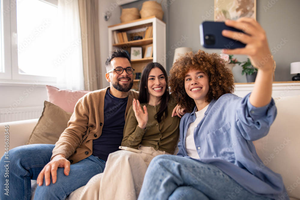 Three Friends Smiling on a Couch Taking a Selfie in a Cozy and Bright Living Room Three Friends Smiling on a Couch Taking a Selfie in a Cozy and Bright Living Room