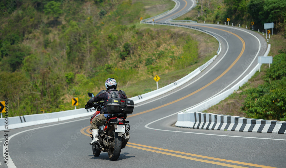 motorcycle on the road rides away. Travel on vacation, enjoy the nature trail. motorcycle in a sunny motorbike on the road riding.with sunset light. copyspace for your individual text.. motorcycle on the road rides away. Travel on vacation, enjoy the nature trail. motorcycle in a sunny motorbike on the road riding.with sunset light. copyspace for your individual text..
