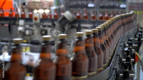Brewery, bottling beer on aluminum kegs on conveyor lines. Industrial work, automated modern food and beverage production