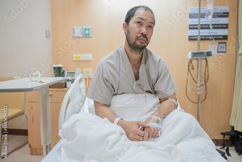 Obraz na płótnie A Hospitalized Patient with Influenza and Gallstones, Receiving IV Therapy and Medications, Under Close Monitoring by Nurses, While Recovering from Abdominal Pain and Surgery w salonie