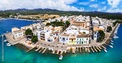 Mallorca island landmarks. Scenic fishing village Portocolom with colorful houses and boats . Popular tourist destination. Balears, Spain. aerial panoramic drone view