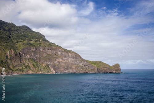 Majestic cliffs meet tranquil waters on the coast of Madeira Island, showcasing natural beauty and serenity in a breathtaking landscape