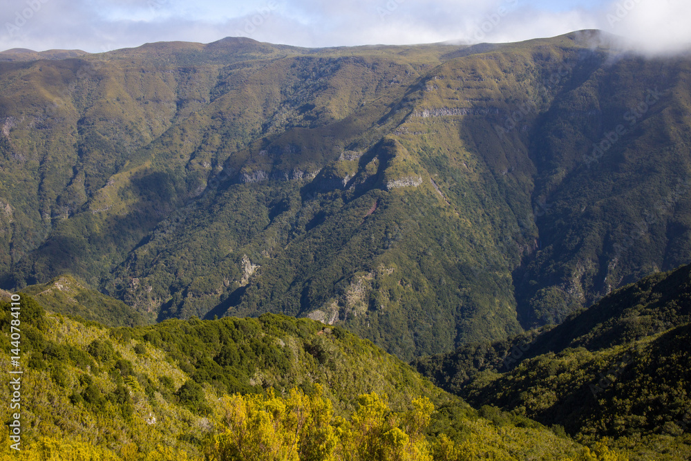 Explore the breathtaking landscapes of Madeira with its stunning mountain ranges and lush green valleys under a clear blue sky